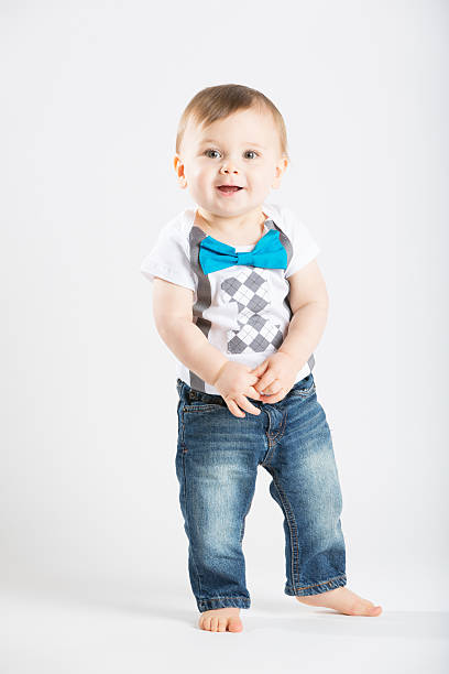 istock Baby Standing Holding Hands Looking Cute 495238616