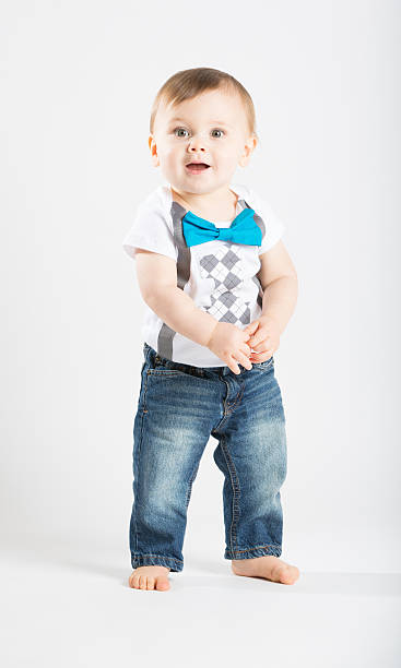 istock Baby Standing Holding Hands Looking Surprised 495238656