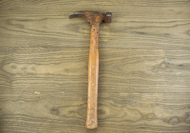 istock Old Rusty claw Hammer on aged wood 495239063