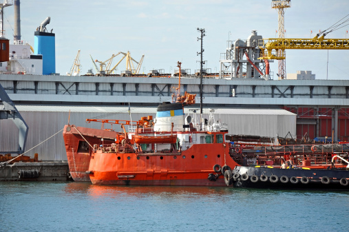 Bunker ship and tugboat under port crane, Odessa, Ukraine