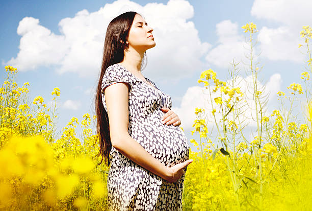Hermosa mujer embarazada disfruta de colza Campo - foto de stock