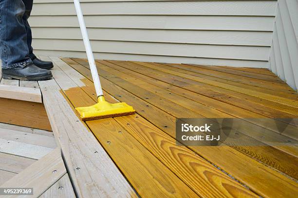 Worker Applying Stain To Deck Stock Photo - Download Image Now - Deck, Wood Stain, Painting - Activity