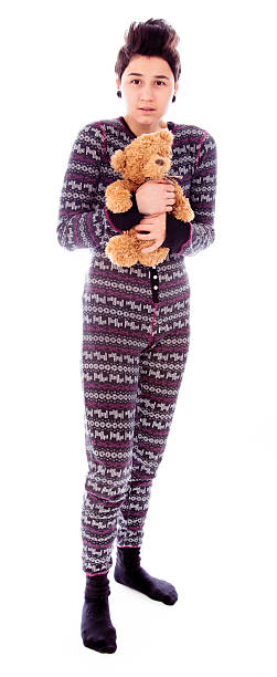 istock Young woman shivering and holding teddy bear 495239519