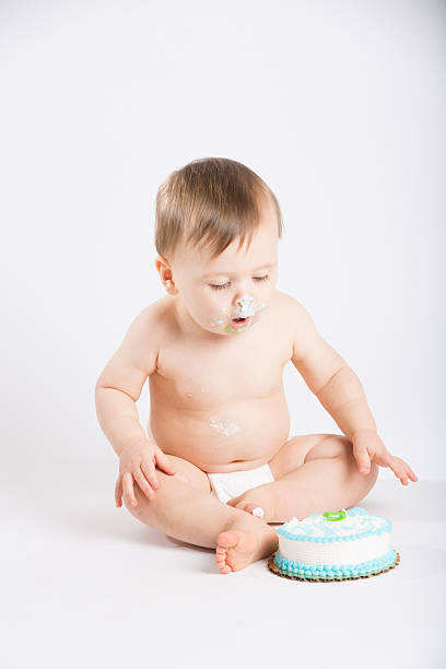 istock Baby Looking Down at Cake with Face Full of Icing 495239794