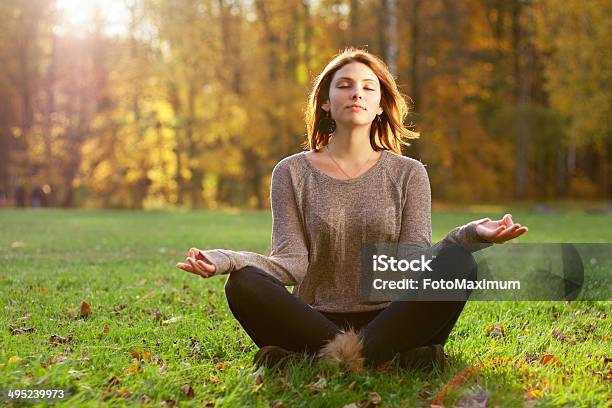 Beautiful Young Girl Meditating In Autumn Park Stock Photo - Download Image Now - Adult, Adults Only, Autumn