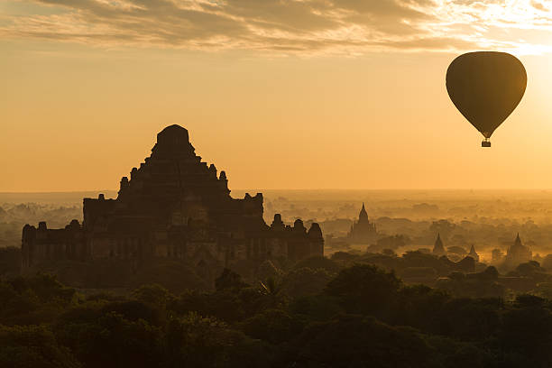 istock Dhammayangyi Temple during sunrise with hot air balloon 495240431