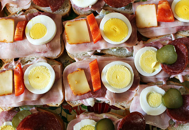 Party sandwiches with ham, cheese, egg and pepper stock photo