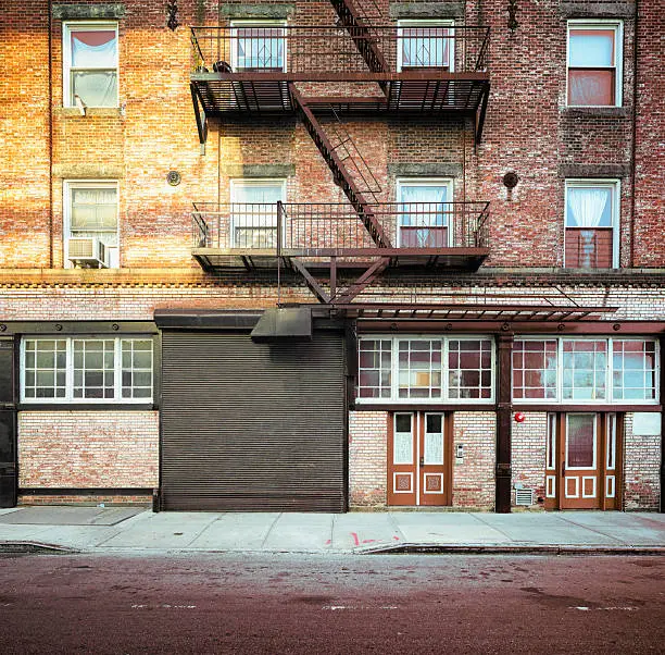 Photo of Brooklyn apartment buildings facade with large steel garage door