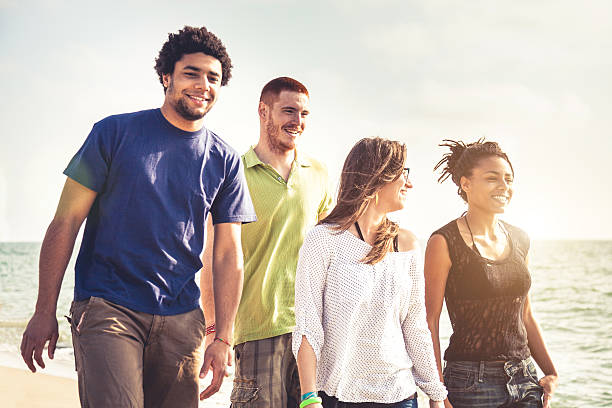 istock Group of multi-ethnic friends walking on the beach 495242973