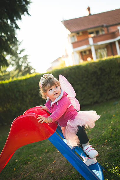 istock Child on slide in back yard 495243026