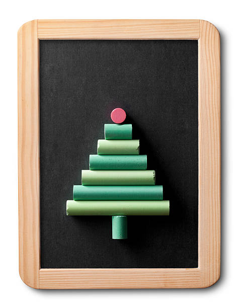 Green chalks on a blackboard Blackboard with green chalks shaped Christmas tree. lavagna stock pictures, royalty-free photos & images
