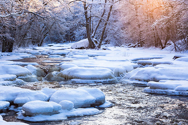 istock Winter landscape by a river in the sunset 495250262