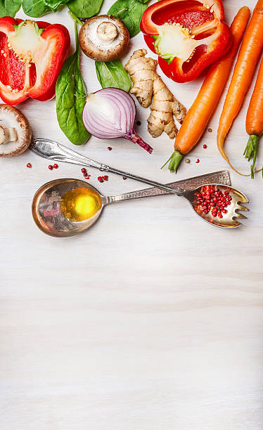 istock Vegetables for Healthy cooking with spoons on light background 495250526