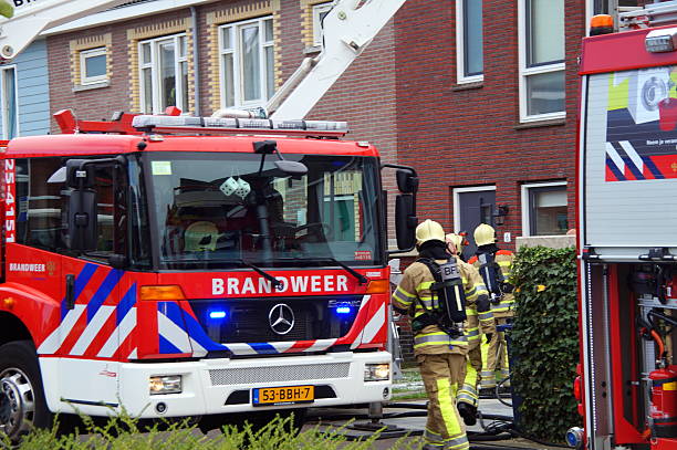 Dutch firefighters fighting fire - home fire stock photo