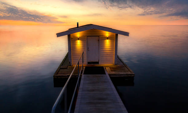 Sauna on a jetty Sauna on a jetty against dreamlight horizon in sunset swedish sauna stock pictures, royalty-free photos & images