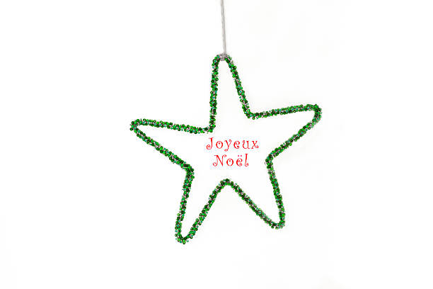 A beaded green Christmas star on a white background with red text that reads \
