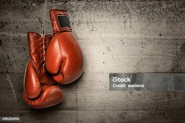 Boxing Gloves Hanging On Concrete Wall Stock Photo - Download Image Now - Boxing - Sport, Boxing Glove, Protective Glove