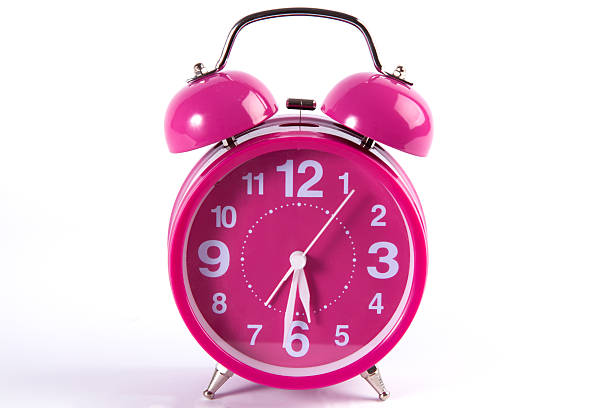 istock Retro pink alarm clock isolated on white 495256624