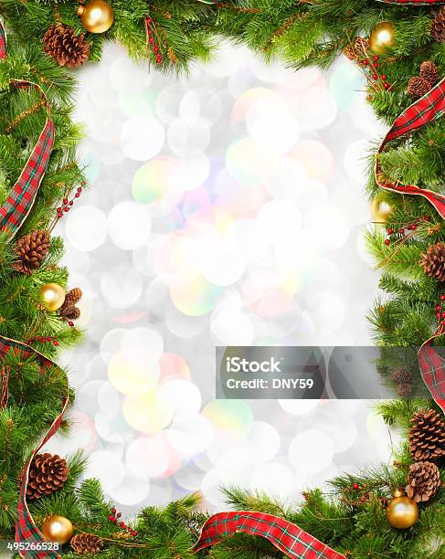Christmas Garland Frame In Front Of Blurred Lights Stock Photo - Download Image Now - Border - Frame, Christmas, Wreath