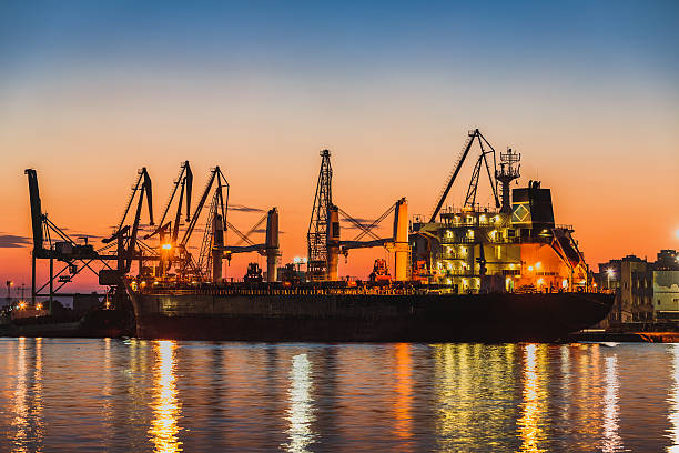 istock Harbor cranes in port and beautiful sunset 495266928
