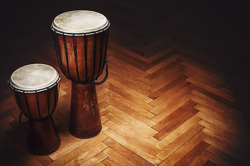 Two old vintage style wooden djembes, percussion instruments from Balkan and Africa.