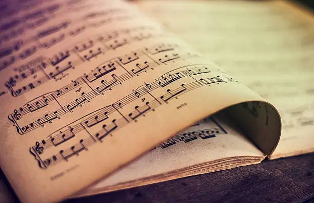 Photo of Music sheets on wooden background