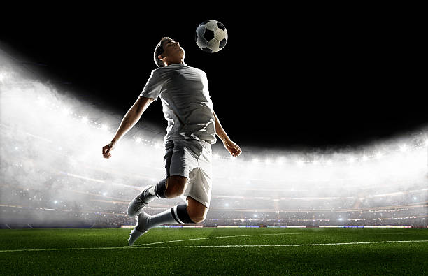 istock Soccer player kicking ball in stadium 495271086
