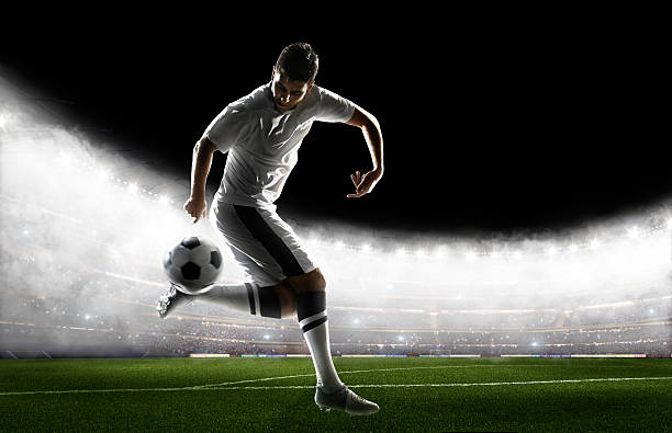 istock Soccer player kicking ball in stadium 495271204