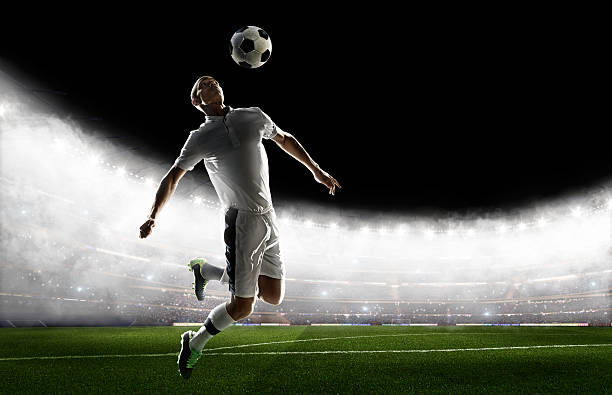 istock Soccer player kicking ball in stadium 495271370