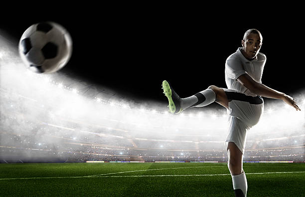 istock Soccer player kicking ball in stadium 495271458