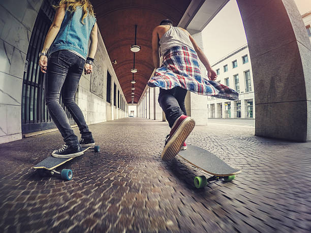 istock Young skaters riding longboard skateboards 495271918