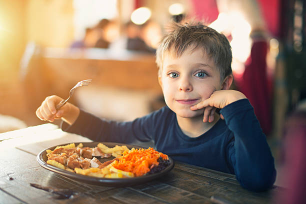 istock Little boy enjoying dinner at the restaurant 495272158