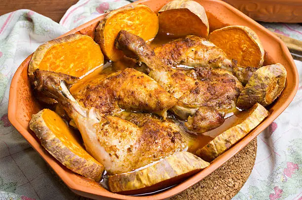 Chicken with sweet potatoes baked in traditional old roman pot