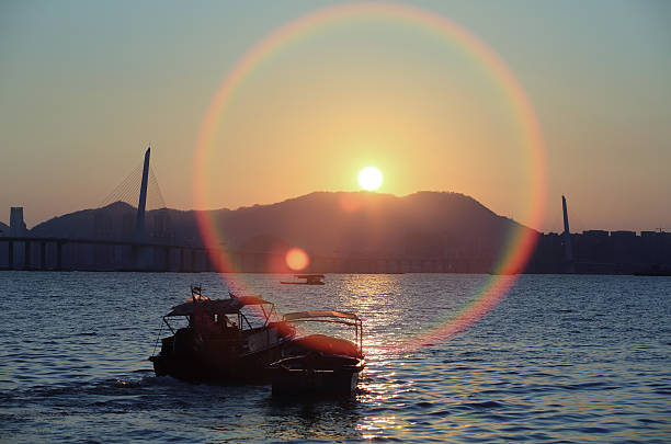 fishing boat pass through the sun blast Deep Bay sea