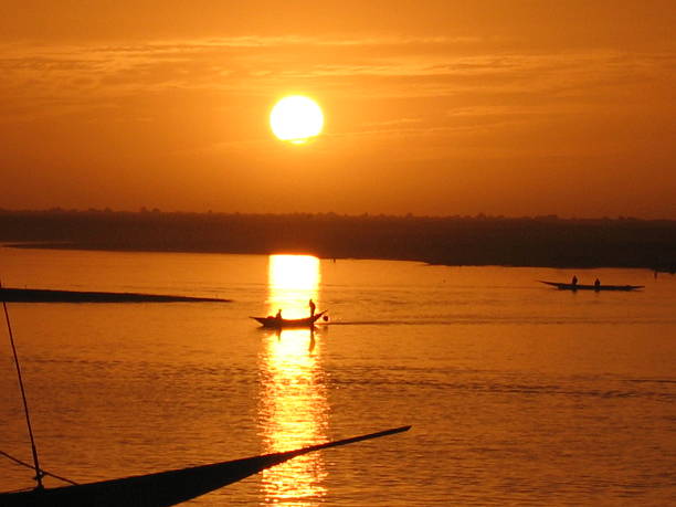 istock Boat on water in sun's reflection at sunset 495280043