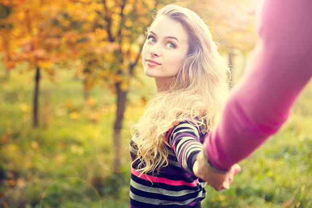 Young Woman Holding Hands on Autumn Background stock photo