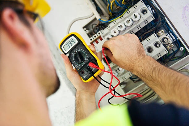 Electrician Testing Voltage A service technician is using a modern multimeter to test the Voltage . electrician multimeter stock pictures, royalty-free photos & images