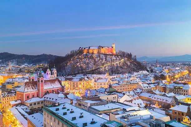 Aerial panoramic view of Ljubljana decorated for Christmas holidays. Roofs covered in snow in winter time. Slovenia, Europe.