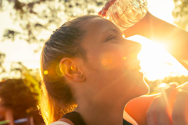 istock Woman using water bottle to cool down. 495291722