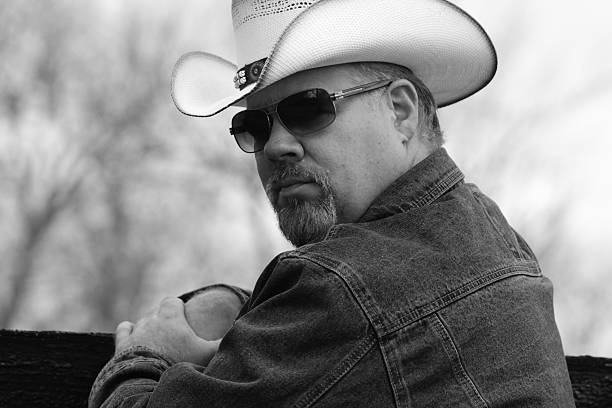 istock Black and White Image of Cowboy Looking Over Shoulder 495292592