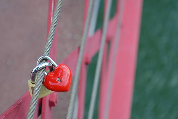 istock Red heartshaped locket and padlock locked together 495294148