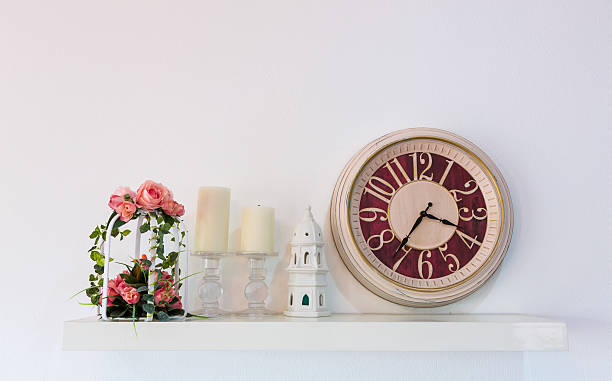 istock wall decorated with clocks ,flower and candle 495301375