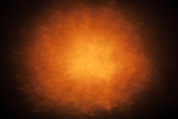 istock Abstract background with orange glowing spot light 495302641