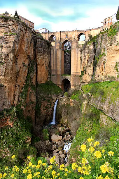 Puente Nuevo bridge at evening time in Ronda with waterfall, Andalucia, Spain