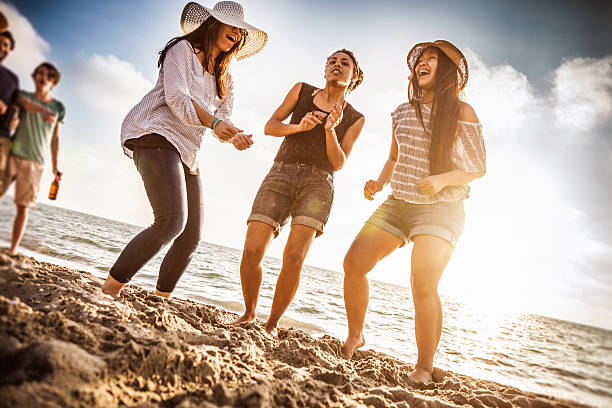 istock Multi-ethnic group of friends dancing on the beach 495303233