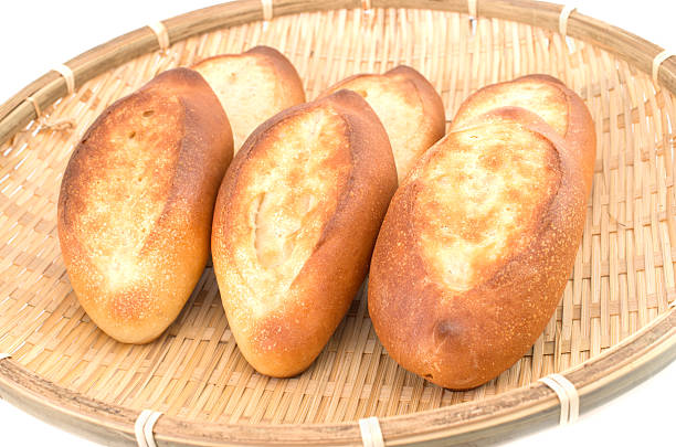 istock Mini french baguettes in a bamboo plate on white background 495303991