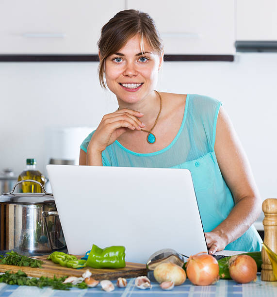 istock Girl at kitchen casserole and vegetables 495311110