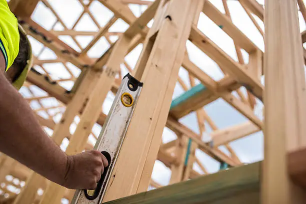 Photo of Construction worker checking level
