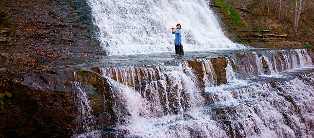 istock Woman performing  musical in waterfall 495314706