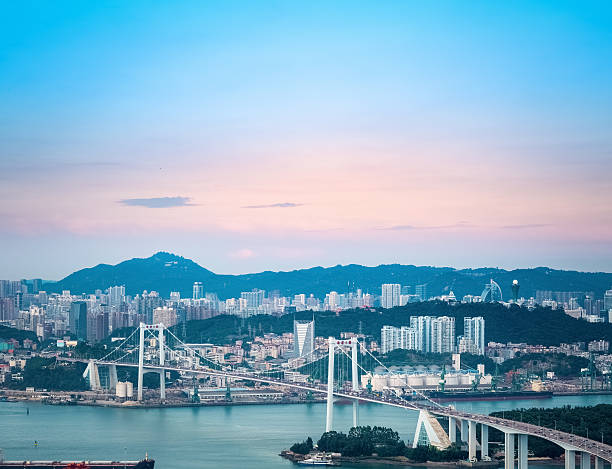 istock bridge and city in sunset 495315152